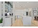 Modern kitchen with sleek white cabinetry, stainless steel appliances, and center island with seating at 560 Dutch Vly # 02313, Atlanta, GA 30324