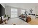 Well-lit living room with modern fireplace, stylish decor, and large windows with sheer curtains at 560 Dutch Vly # 02313, Atlanta, GA 30324