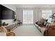 Bright living room with modern decor, large windows with sheer curtains, and stylish furnishings at 560 Dutch Vly # 02313, Atlanta, GA 30324
