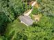 Aerial view of a charming home nestled among lush green trees, offering privacy at 5706 Forest Pl, Acworth, GA 30102