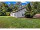 Side view of home featuring a grassy yard and landscaping at 5706 Forest Pl, Acworth, GA 30102