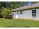 Side view of house featuring a grassy yard at 5706 Forest Pl, Acworth, GA 30102