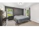 Comfortable bedroom with neutral tones, plush carpet, and two bright windows at 5706 Forest Pl, Acworth, GA 30102