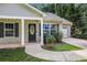 Inviting home featuring a decorative front door, landscaped yard, and an attached garage at 5706 Forest Pl, Acworth, GA 30102