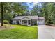 Charming single-story home with manicured lawn, mature trees, and an attached one-car garage at 5706 Forest Pl, Acworth, GA 30102