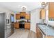 Modern kitchen featuring stainless steel appliances, wooden cabinets, and stylish lighting at 5706 Forest Pl, Acworth, GA 30102