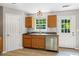 Kitchen area featuring wood cabinetry, stainless steel dishwasher, and views to the backyard at 5706 Forest Pl, Acworth, GA 30102