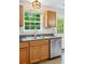 Kitchen with wood cabinets and stainless steel dishwasher at 5706 Forest Pl, Acworth, GA 30102