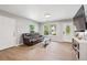 Inviting living room features wood floors, a comfortable couch, and a bright window view at 5706 Forest Pl, Acworth, GA 30102