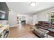 Inviting living room with wood floors, and an opening to the kitchen and dining area at 5706 Forest Pl, Acworth, GA 30102