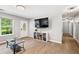 Bright living room with tiled floors, natural light, and a decorative front door at 5706 Forest Pl, Acworth, GA 30102
