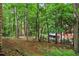 Backyard view showing mature trees behind the home at 1605 Saint Tropez Way, Atlanta, GA 30350