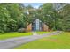 Charming exterior elevation of brick home features a blue front door and lush, green landscaping at 1605 Saint Tropez Way, Atlanta, GA 30350