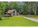Beautiful home with a blue door, surrounded by a lush green lawn and mature trees at 1605 Saint Tropez Way, Atlanta, GA 30350