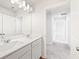 Bathroom with a double sink vanity, modern lighting, and a glimpse into a hallway at 2058 Brookhill Way, Snellville, GA 30078