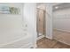 Bathroom featuring a tub and separate shower with a view of a walk-in closet at 2058 Brookhill Way, Snellville, GA 30078