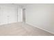 Bright bedroom featuring neutral carpet, crisp white walls, double closets, and an adjacent doorway at 2058 Brookhill Way, Snellville, GA 30078