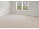Bedroom with neutral carpet, two windows and walls painted white at 2058 Brookhill Way, Snellville, GA 30078