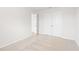 Bright bedroom featuring neutral carpet, crisp white walls, double closets, and an adjacent doorway at 2058 Brookhill Way, Snellville, GA 30078
