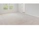 Large primary bedroom with neutral carpet and two windows at 2058 Brookhill Way, Snellville, GA 30078