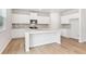Modern kitchen with white cabinets, granite counters, stainless appliances, and island at 2058 Brookhill Way, Snellville, GA 30078
