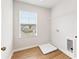 Laundry room with shelving, wood look floors, and natural light at 2058 Brookhill Way, Snellville, GA 30078