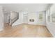 Open concept living room with wood-look floors and white shiplap fireplace at 2058 Brookhill Way, Snellville, GA 30078