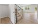 Staircase leading to a living room with fireplace and sliding glass doors at 2058 Brookhill Way, Snellville, GA 30078
