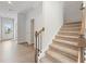 Carpeted staircase with stained wood railing and black iron balusters at 2058 Brookhill Way, Snellville, GA 30078