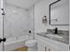 Modern bathroom featuring white marble tile in the shower, black fixtures and hardware and a granite vanity at 144 Cathy Ln, Hiram, GA 30141