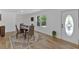 Well-lit dining room with hardwood floors, a view of the front yard, and a classic, neutral color scheme at 144 Cathy Ln, Hiram, GA 30141