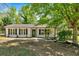 Charming single-story home featuring a well-manicured front yard and inviting curb appeal with black shutters at 144 Cathy Ln, Hiram, GA 30141