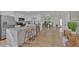 Open concept kitchen with white cabinets, stainless steel appliances, and an island with barstool seating at 144 Cathy Ln, Hiram, GA 30141