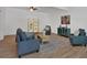 Cozy living room features wood floors, comfortable seating, and bright, natural light at 144 Cathy Ln, Hiram, GA 30141
