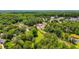 Residential property with lush trees near a commercial area; blends nature with the convenience of nearby shops at 407 E College E St, Bowdon, GA 30108