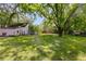 Large backyard with mature trees and detached garage at 407 E College E St, Bowdon, GA 30108