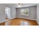 Bedroom boasts natural light, hardwood floors, and neutral paint, creating a blank canvas at 407 E College E St, Bowdon, GA 30108