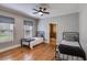 Bright bedroom featuring two twin beds, hardwood floors, and natural light from large windows at 407 E College E St, Bowdon, GA 30108