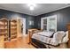 Cozy bedroom boasts hardwood floors, neutral paint, and natural light for a comfortable and serene retreat at 407 E College E St, Bowdon, GA 30108