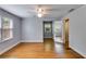 Bright, airy bedroom with hardwood floors, natural light, and a doorway leading to another room at 407 E College E St, Bowdon, GA 30108