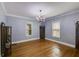 Elegant dining room with hardwood floors, chandelier, and windows for a bright and inviting atmosphere at 407 E College E St, Bowdon, GA 30108