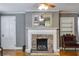 Living room fireplace with stone surround and mantel at 407 E College E St, Bowdon, GA 30108
