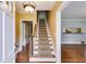 Foyer featuring hardwood floors, a staircase, and an open view into the adjoining living spaces at 407 E College E St, Bowdon, GA 30108
