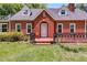 Attractive brick home with dormer windows and a landscaped front yard with a well-manicured lawn at 407 E College E St, Bowdon, GA 30108