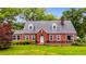 Charming brick home with a well-maintained lawn, mature trees and dormer windows at 407 E College E St, Bowdon, GA 30108