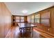Spacious game room featuring wood floors, wood paneling, multiple windows and a ping pong table at 407 E College E St, Bowdon, GA 30108