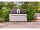 Detached two-car garage with white doors at 407 E College E St, Bowdon, GA 30108