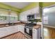 Bright kitchen features stainless steel appliances, ample cabinet space, and a stylish countertop for cooking at 407 E College E St, Bowdon, GA 30108