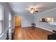 Inviting living room features gleaming hardwood floors, neutral walls, and a ceiling fan for added comfort at 407 E College E St, Bowdon, GA 30108