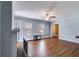 Spacious living room boasts hardwood floors, fireplace, neutral paint, and ample natural light from large windows at 407 E College E St, Bowdon, GA 30108